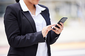 Image showing Online, networking business woman in a suit and smartphone reading email communication, WhatsApp or mobile project management app on the go. Corporate professional hands typing on smartphone in city