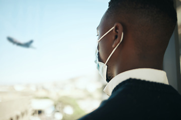 Image showing Businessman in an airport for work travel during covid with a mask and plane fly in the background. Entrepreneur, employee or corporate professional watching an airplane while waiting to board flight