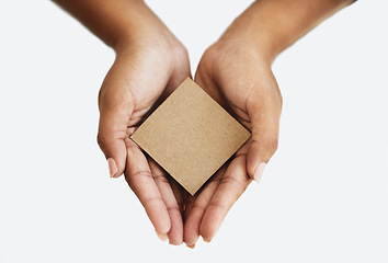 Image showing Closeup of the hands of a person showing a message, advertising a product or holding an empty paper or a cardboard card against a white background. Top view of woman promoting an item or sign