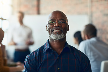 Image showing Mature business man sitting in a meeting, conference or seminar in a boardroom with colleagues at work. Closeup portrait of face of a senior, happy and corporate professional in a training workshop