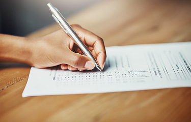 Image showing Her opinion matters. Closeup of a female hand filing in paperwork for a formal application or survey. A woman writing on a form applying for a financial loan, completing a list or questionnaire.