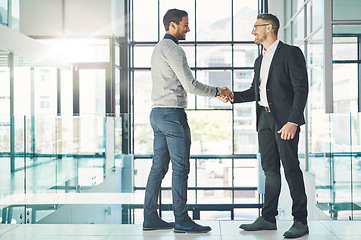 Image showing Handshake, teamwork and working together with corporate business men and colleagues at work as a team. Making a deal during a meeting, greeting and coming to an agreement in a modern office