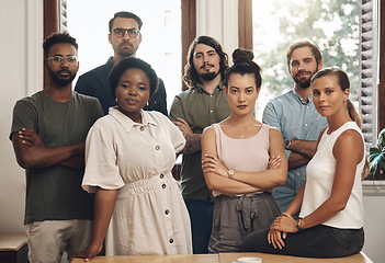 Image showing Serious business people standing with arms crossed, looking confident and showing teamwork in an office together at work. Portrait of diverse creative employees expressing power, unity and success