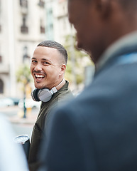 Image showing Real life young man portrait in the street with headphones, enjoying music on a playlist app looking happy, stressless and cool. Normal face of a millennial with wireless tech outside an urban city