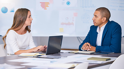 Image showing Collaboration, teamwork and planning team of social media marketing and advertising professionals talking in strategy meeting. A man and woman working on a messy office, workstation or workplace desk