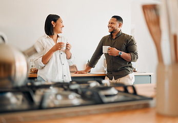 Image showing Loving couple drinking coffee and talking, bonding and having fun while spending time together at home. Smiling, in love and carefree couple hugging and sharing a romantic moment enjoying the morning