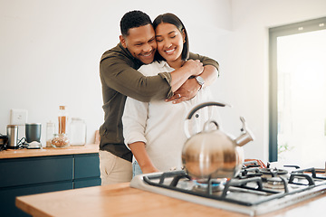 Image showing Romantic, love and bonding couple hugging while enjoying quality time together at home. Loving husband showing affection, care and embrace to his relaxing wife while making tea in the kitchen