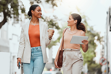 Image showing Startup entrepreneurs, female friends or design students discussing fashion project over coffee. Trendy stylish designers or girls walking together to agency in modern urban city with digital tablet
