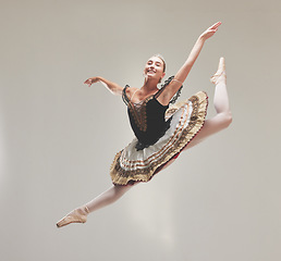 Image showing Elegant ballet dancer dancing with a vintage style, jumping and performing in a studio. Portrait of a skilled, talented and young ballerina leaping high in the air enjoying her performance