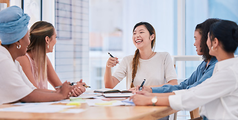 Image showing A diverse business team of females only in a meeting laughing and smiling due to a positive mindset, mission and vision. Group of happy and excited businesswomen planning in a boardroom