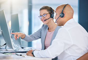 Image showing Call centre agent, telemarketing and sales representative colleague with desktop computer talking, showing or looking at online software app or website. Global business agency manager discussing work