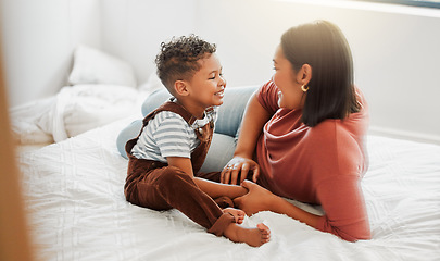 Image showing Childcare, love and caring mother playing with toddler son in bedroom, teaching him to talk in a bed room at home. Single parent or mom showing love, affection and care for baby boy, bonding together