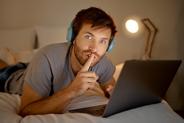 Image showing Laptop, portrait and quiet hand gesture from man trying to focus. Insomnia or workaholic reading emails at night in his bedroom. Silence expression from person for silent environment while working.