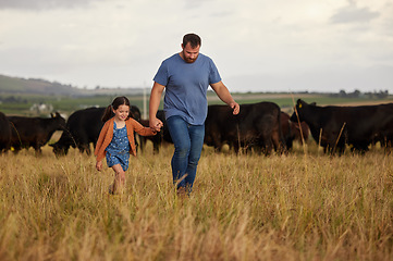 Image showing Farmer father, child or family with cows on a farm, grass field or countryside. Sustainability or environmental dad and girl with cattle in background for meat, beef or agriculture growth industry