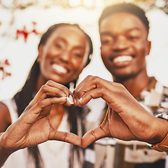 Image showing Heart hands, emoji and love of couple smile, happy and showing kindness, trust and support. Closeup of young black people together in romantic relationship celebrate honeymoon with with content bond