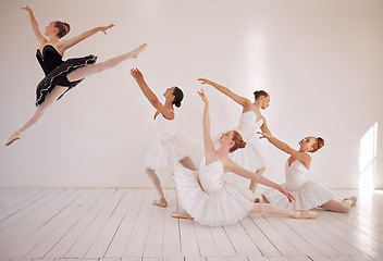 Image showing Ballet, jump and dance class studio for professional sports woman. Female performance art students in training for ballerina recital. Elegant, passionate and energetic dancer girl flying in the air.