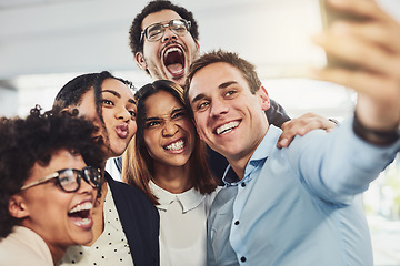 Image showing Teamwork, playful and selfie while a group of cheerful businesspeople making funny faces together for a social media post. Faces of a happy and fun team standing together in a creative office