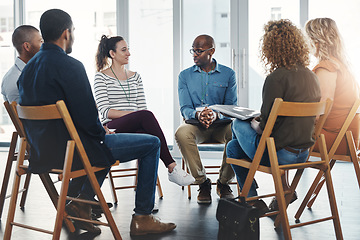 Image showing A group therapy session with diverse people sharing their sad problems and stories. People sitting in a circle talking about their mental health issues and looking for support, help and counseling