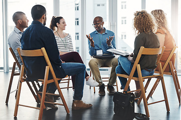 Image showing Business people in an informal meeting, team building discussion or group project planning session. Leader, manager or supervisor talking to diverse colleagues or employees about workflow management