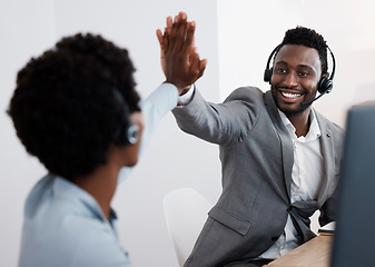 Image showing High five, congratulations and success with support staff or customer service personnel working together in a call center. Closing a deal, making a sale solving a problem to help and assist online