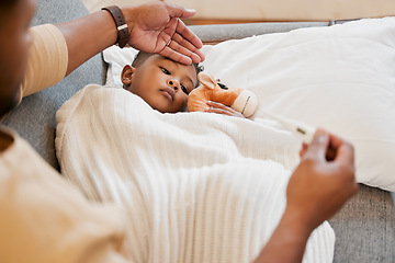 Image showing Sick, flu and cold child in bed, sad and ill with allergy and unwell at home with his worried mother. Parents hand on sons forehead for his temperature as she checks his fever with a thermometer