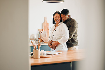 Image showing Hugging, happy and excited couple spending quality time together and relaxing at home. Loving, relaxed and affectionate African lovers embracing, cuddling and having fun in the house