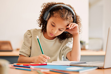 Image showing Smart school child, student virtual learning while writing in her book inside an education classroom. Creative with headphones drawing art on paper. Cute, artistic little kid doing homework