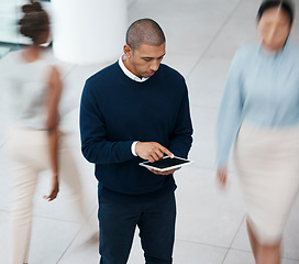 Image showing Busy office with business man on tablet browsing, planning and scrolling for online research, mobile notes and digital ideas from above. Organized entrepreneur working on plan in a bustling workplace