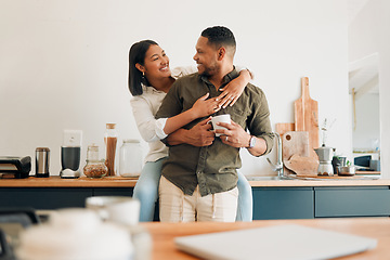 Image showing Happy, hugging and romantic couple bonding and feeling united, supported and in love. Cheerful and relaxed married man and woman embracing in home kitchen during morning coffee routine break