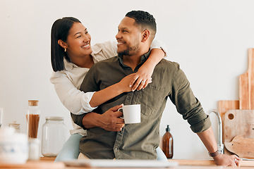 Image showing Happy, coffee and loving couple bonding and having fun while spending time together at home. Smiling, in love and carefree couple hugging and sharing a romantic moment while enjoying the weekend