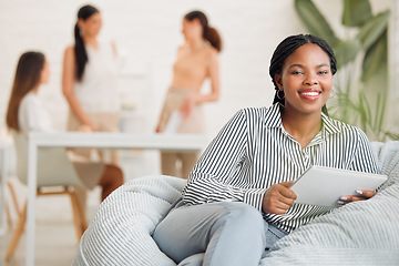 Image showing Creative black woman on social media, with tablet and checking online while on a work break. Happy young lady boss of ecommerce startup, relaxing before a business meeting business with her girl team