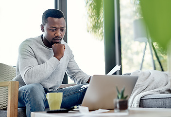 Image showing Finance, stress and worried black man paying bills on a laptop while doing paperwork at home. Concerned, anxious male checking budget, getting bad news or negative feedback of a rejected loan or debt