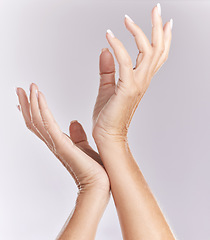 Image showing Soft, manicure hands or beauty treatment closeup of female model palms touching in elegant hand pose isolated on purple studio background. Skincare, nails care or antiaging wrinkle free body part