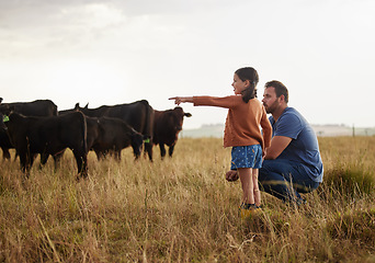 Image showing Family, dairy farming and farmer with child, daughter and girl pointing, showing and watching cows or cattle. Father and curious kid bonding on farm estate with meat, beef and food industry livestock