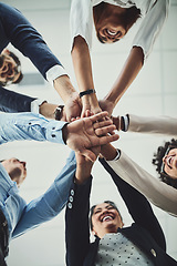 Image showing Hands stacked and piled showing team unity, strength or motivation among creative business colleagues from below. Excited, laughing and huddled group of inspired business people ready for success