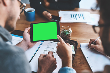 Image showing Green screen, copyspace and chromakey on a tablet screen in the hands of a business man in a meeting in a boardroom. Advertising, marketing and online promotion with colleagues pointing at copyspace