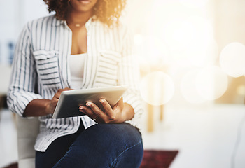 Image showing Business woman typing on a tablet, replying to emails and checking notifications while sitting in office at work. Manager, professional worker and creative designer searching the internet for ideas