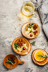 Image showing Delicious white mulled wine with apples, cranberries and spices