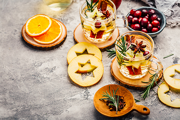 Image showing Delicious white mulled wine with apples, cranberries and spices