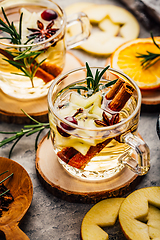 Image showing Delicious white mulled wine with apples, cranberries and spices