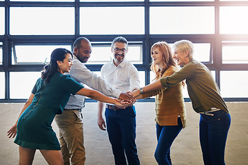 Image showing Teamwork, fun and collaboration by diverse team joining hands in team building. Excited group linking, joining and supporting goal, mission or vision at work. Trust by professional creative coworkers