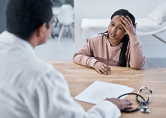 Image showing Sick, ill or stressed patient with doctor talking in medical consultation, checkup or visit in clinic, hospital or healthcare center. Tired woman with headache explaining symptoms to professional gp