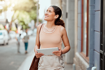 Image showing Vision, ambitious and inspired creative woman walking in an urban city holding a digital tablet. Female designer exploring, visiting and enjoying a sightseeing in a town outdoors for inspiration.