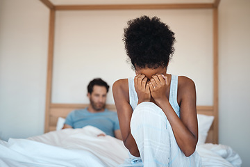 Image showing Woman crying after fighting with husband in bedroom at home. Wife sad after husbands affair, lies and cheating in the bed. Depressed couple having relationship problems and decide to get a divorce