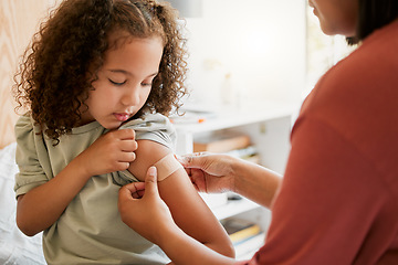 Image showing Covid nurse vaccinating child putting a bandage on at a clinic. Doctor applying plaster on girl after an injection at health centre. Pediatric, immunity and prevention at medical childrens hospital