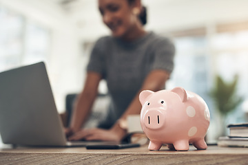Image showing Finance, banking and saving money with piggybank, investing and planning while working on a laptop in an office at work. Managing and growth of budget for insurance, investment and retirement