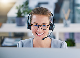 Image showing Call center agent helping clients online while talking on a headset in a modern office, enjoying her career. Customer service and support with a happy, friendly woman excited to guide and answer