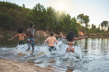 Image showing Nature, vacation and friends having fun swimming on lake trip together, enjoying outdoors summer holiday. Young joyful people making a splash in swimwear or bikini on an adventure break