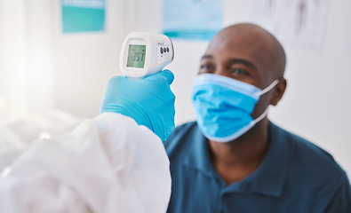 Image showing Checking for covid, corona or fever with a patient wearing a mask for hygiene, sickness or flu symptoms in a health clinic. Medical doctor holding a thermometer to scan the temperature of a patient