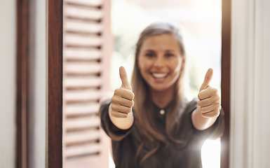 Image showing Thumbs up from a happy woman smiling while showing a hand winning gesture in a modern office. Cheerful, positive female looking excited after getting good news, feedback or a promotion at work